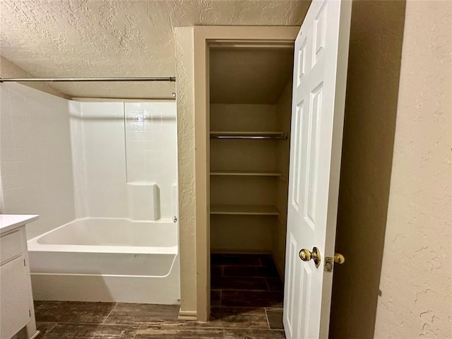 20973 US Highway 62, Altus, OK 73521 - bathroom featuring vanity, tub / shower combination, a closet, a textured wall, and a textured ceiling