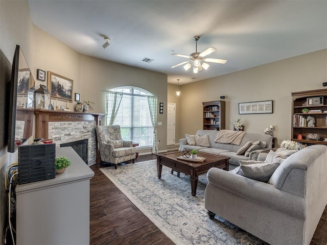 1816 Concord Pl, Norman, OK 73071 - living area featuring a ceiling fan, dark wood-type flooring, a stone fireplace, and baseboards