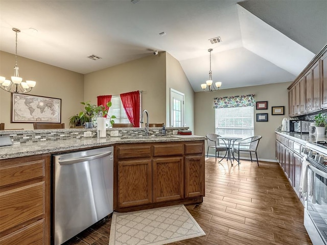 1816 Concord Pl, Norman, OK 73071 - kitchen featuring appliances with stainless steel finishes, a chandelier, a sink, dark wood-style floors, and brown cabinets