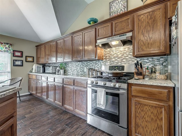 1816 Concord Pl, Norman, OK 73071 - kitchen with appliances with stainless steel finishes, under cabinet range hood, lofted ceiling, tasteful backsplash, and dark wood-type flooring