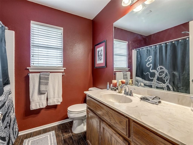 1816 Concord Pl, Norman, OK 73071 - full bathroom with wood finish floors, vanity, toilet, baseboards, and a textured wall