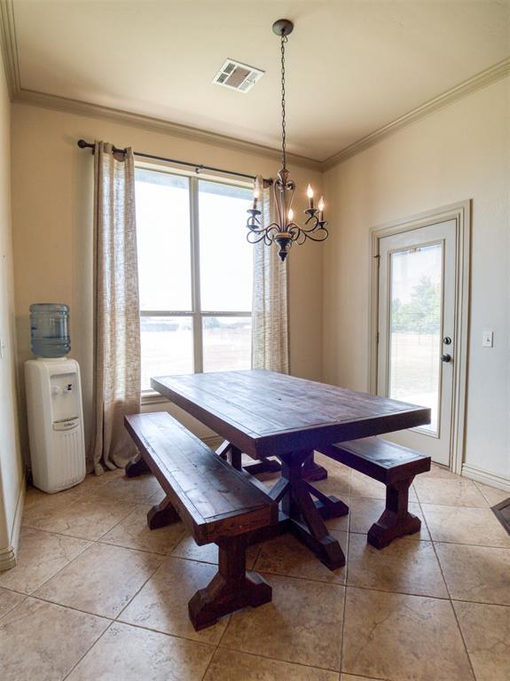 866 County St Unit 2922, Tuttle, OK 73089 - dining area with a chandelier, crown molding, baseboards, and light tile patterned floors