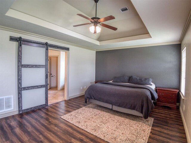 866 County St Unit 2922, Tuttle, OK 73089 - bedroom with a raised ceiling, a barn door, wood finished floors, baseboards, and crown molding