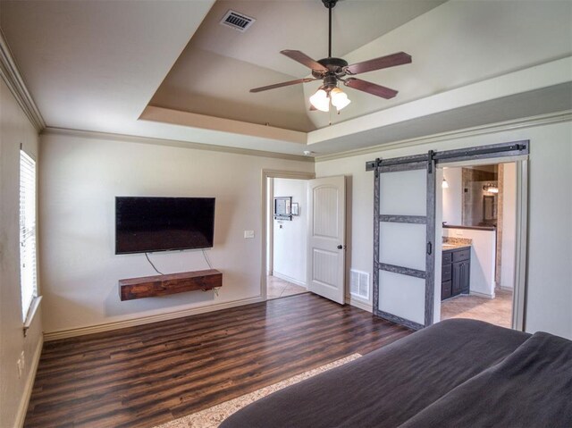 866 County St Unit 2922, Tuttle, OK 73089 - bedroom featuring a barn door, wood finished floors, baseboards, a raised ceiling, and crown molding