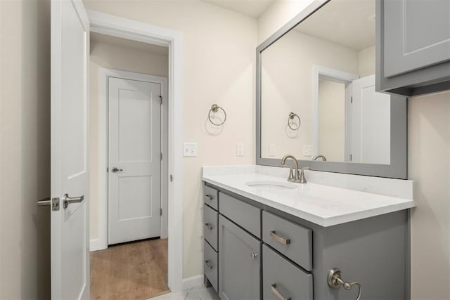 1208 Ariana St, Shawnee, OK 74804 - bathroom with vanity, baseboards, and wood finished floors