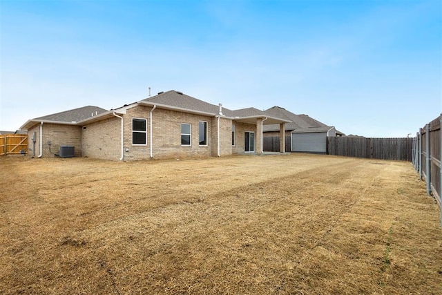 1208 Ariana St, Shawnee, OK 74804 - back of house with central air condition unit and brick siding