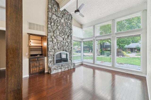 4208 Briarcrest St, Norman, OK 73072 - unfurnished living room featuring a ceiling fan, hardwood / wood-style flooring, a stone fireplace, healthy amount of natural light, and high vaulted ceiling
