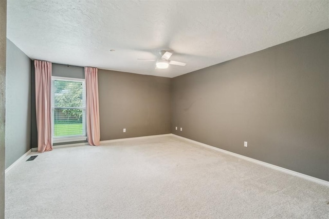 4208 Briarcrest St, Norman, OK 73072 - spare room with a textured ceiling, carpet flooring, and a ceiling fan
