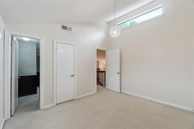 4208 Briarcrest St, Norman, OK 73072 - unfurnished bedroom with carpet floors, vaulted ceiling, and connected bathroom