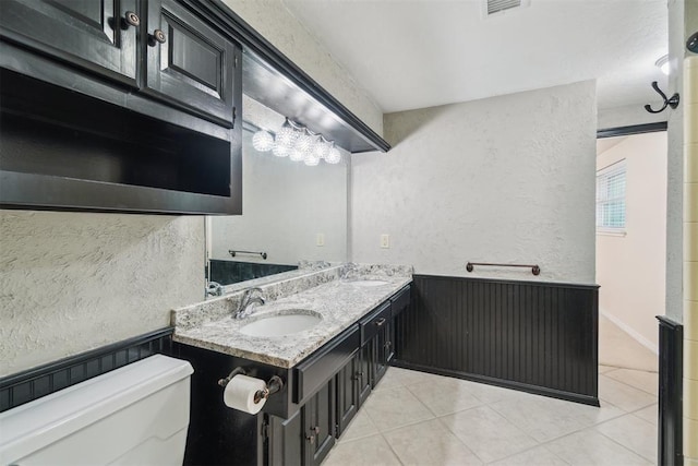 4208 Briarcrest St, Norman, OK 73072 - bathroom featuring tile patterned floors, a textured wall, and double vanity