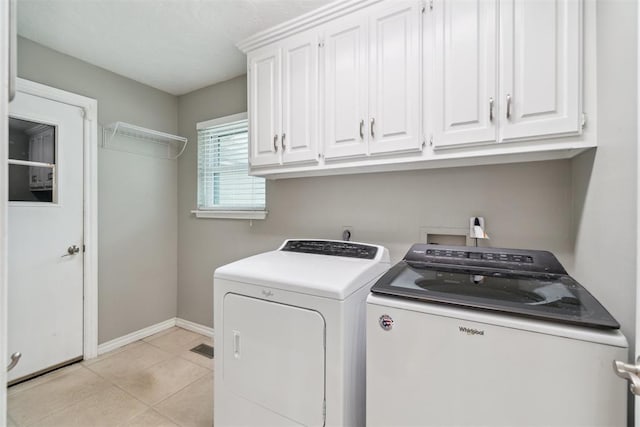 4208 Briarcrest St, Norman, OK 73072 - laundry area featuring cabinet space, washer and clothes dryer, and light tile patterned flooring