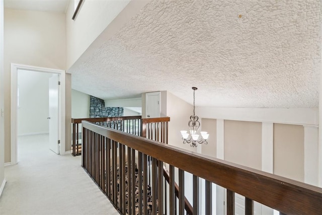 4208 Briarcrest St, Norman, OK 73072 - corridor with a chandelier, carpet, an upstairs landing, and a textured ceiling