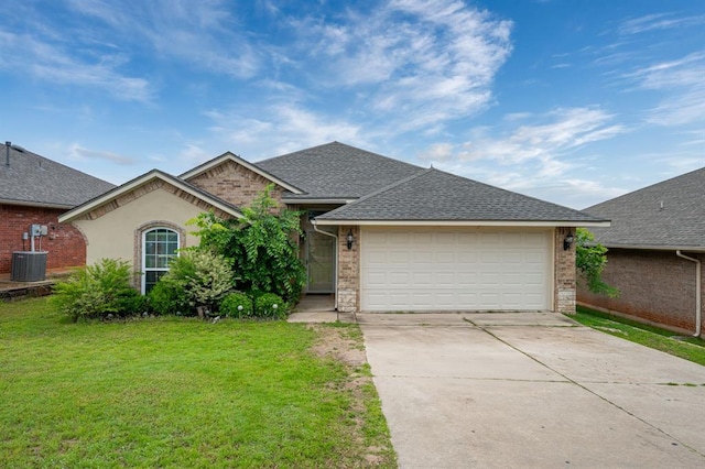 2365 Turtlewood River Rd, Midwest City, OK 73130 - view of front of house with driveway, a front yard, an attached garage, a shingled roof, and brick siding