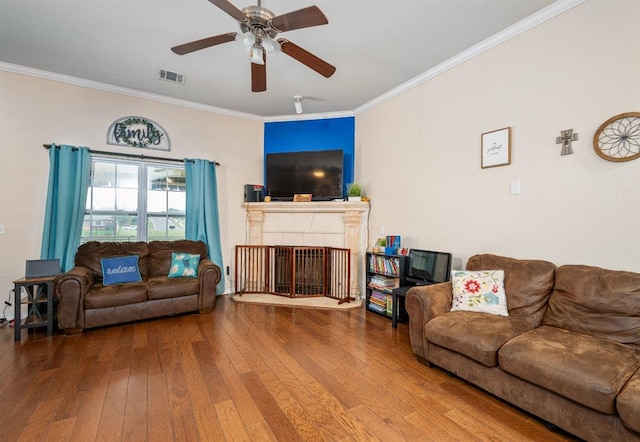 2365 Turtlewood River Rd, Midwest City, OK 73130 - living room featuring hardwood / wood-style floors, crown molding, ceiling fan, and a fireplace