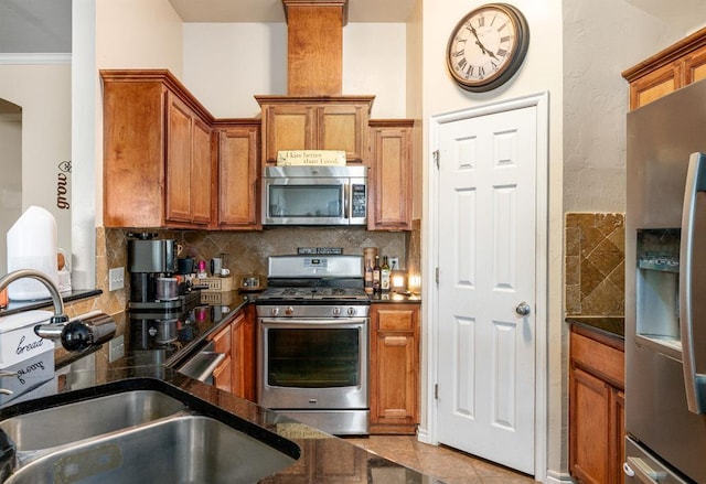 2365 Turtlewood River Rd, Midwest City, OK 73130 - kitchen with stainless steel appliances, a sink, brown cabinets, and backsplash