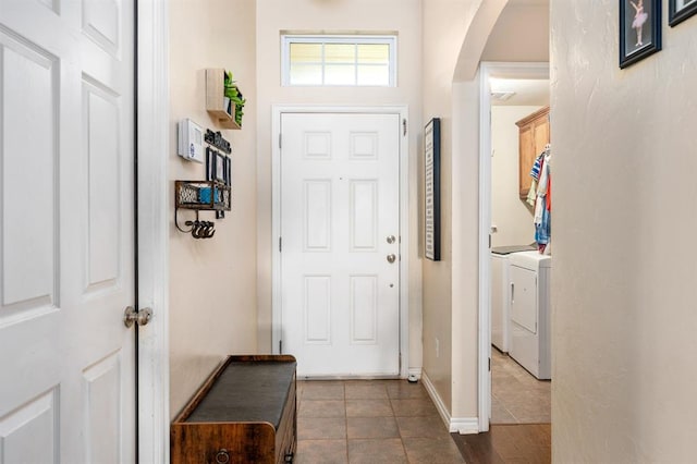 2365 Turtlewood River Rd, Midwest City, OK 73130 - foyer featuring independent washer and dryer, arched walkways, and dark tile patterned floors