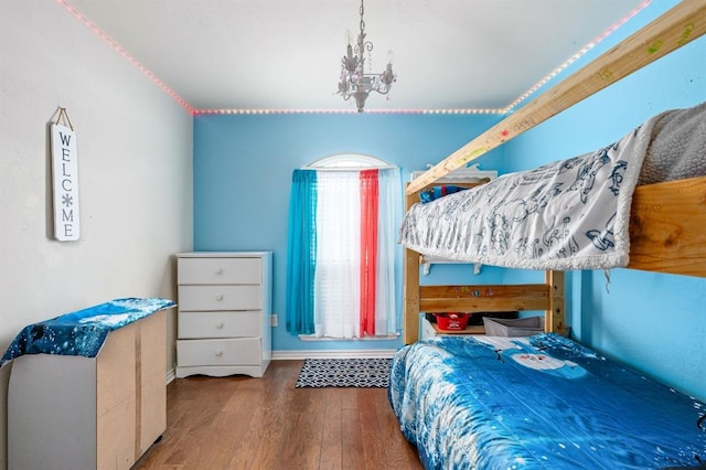 2365 Turtlewood River Rd, Midwest City, OK 73130 - bedroom featuring wood finished floors, a chandelier, and baseboards
