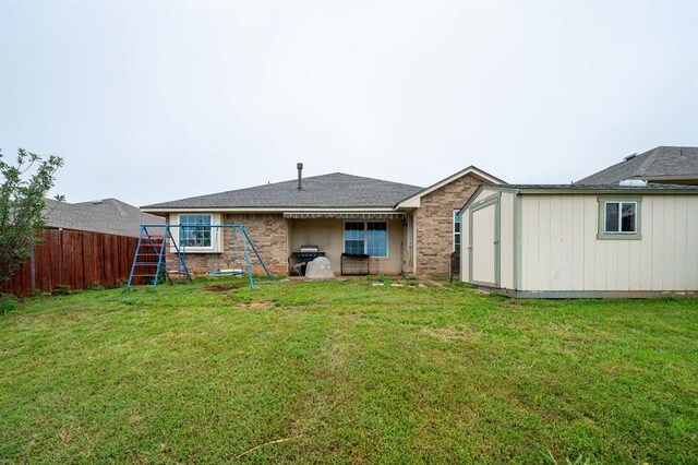 2365 Turtlewood River Rd, Midwest City, OK 73130 - back of house with a playground and brick siding