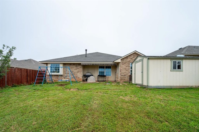 2365 Turtlewood River Rd, Midwest City, OK 73130 - back of house with a playground and brick siding