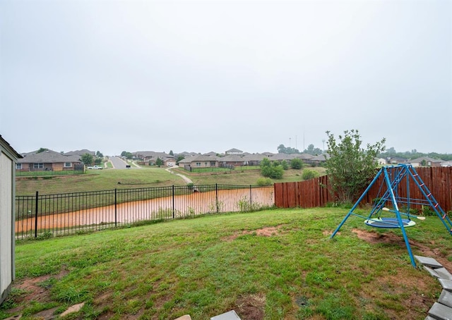 2365 Turtlewood River Rd, Midwest City, OK 73130 - view of yard with a residential view and a playground