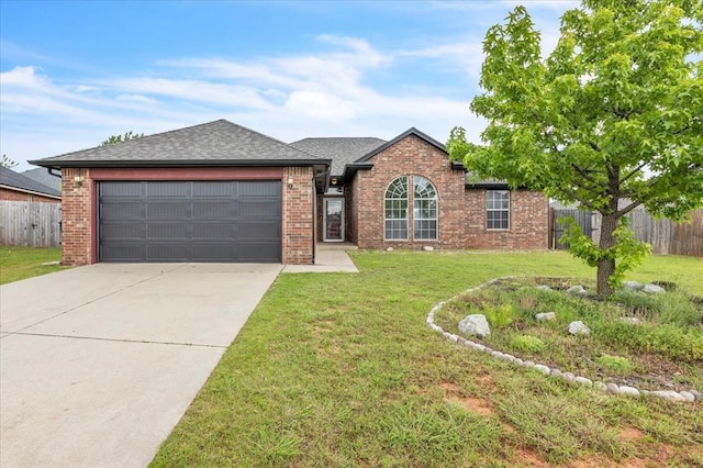 2309 NW 157th Ter, Edmond, OK 73013 - view of front of property featuring brick siding, a garage, driveway, and roof with shingles