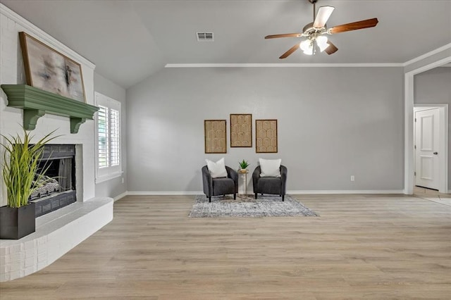 2309 NW 157th Ter, Edmond, OK 73013 - living area with ceiling fan, light wood-type flooring, a brick fireplace, baseboards, and vaulted ceiling