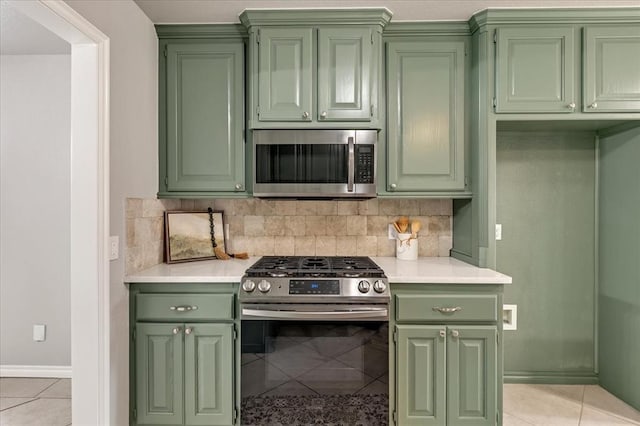 2309 NW 157th Ter, Edmond, OK 73013 - kitchen with green cabinets, appliances with stainless steel finishes, light tile patterned flooring, and light countertops