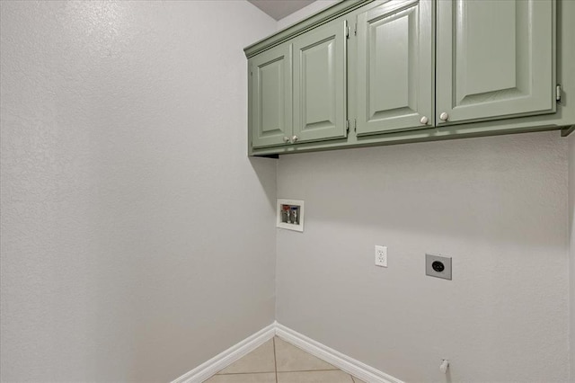 2309 NW 157th Ter, Edmond, OK 73013 - laundry area featuring cabinet space, electric dryer hookup, hookup for a washing machine, light tile patterned floors, and baseboards