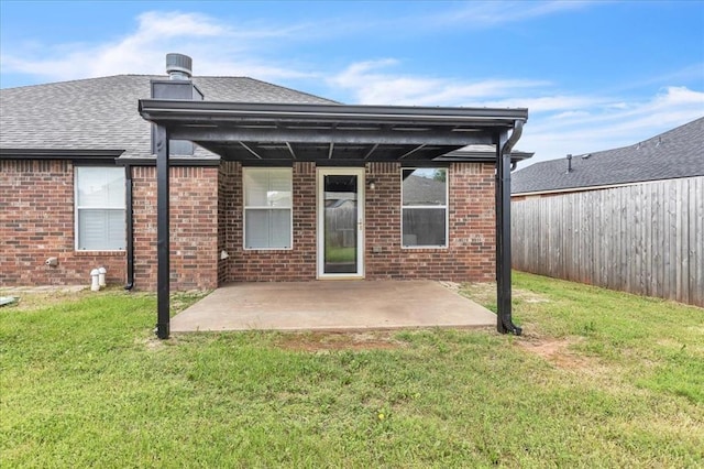 2309 NW 157th Ter, Edmond, OK 73013 - back of property featuring a patio area, a lawn, roof with shingles, and brick siding