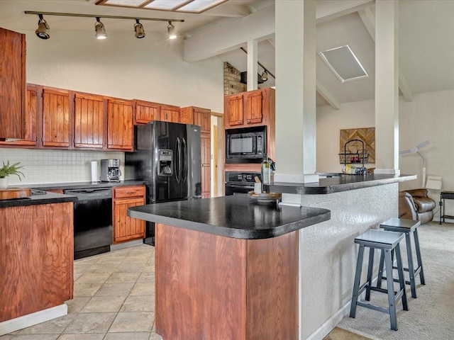 34207 Clearpond Rd, Shawnee, OK 74801 - kitchen with black appliances, track lighting, dark countertops, high vaulted ceiling, and tasteful backsplash