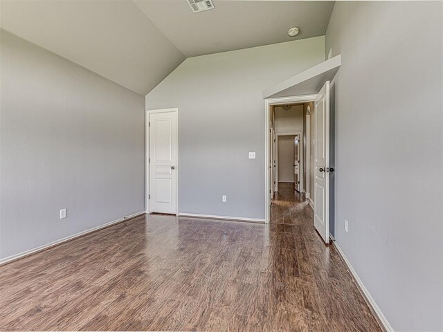 4305 NW 164th Ter, Edmond, OK 73013 - unfurnished room with vaulted ceiling, wood finished floors, a smoke detector, and baseboards