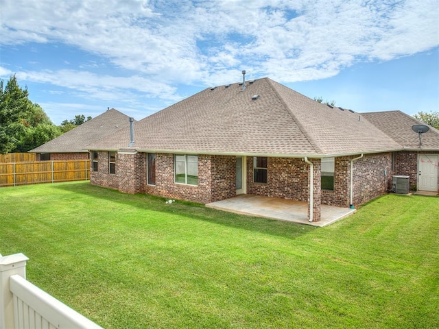 4305 NW 164th Ter, Edmond, OK 73013 - rear view of house featuring cooling unit, a shingled roof, a patio area, and brick siding