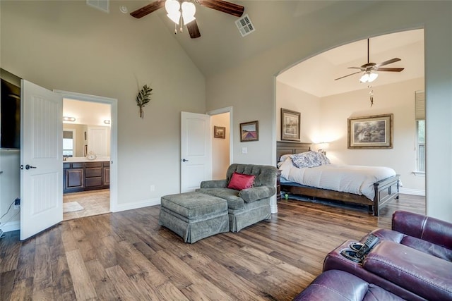 2717 Cordgrass Ln, Edmond, OK 73013 - bedroom featuring high vaulted ceiling, wood finished floors, baseboards, connected bathroom, and a ceiling fan