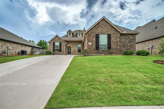 2717 Cordgrass Ln, Edmond, OK 73013 - view of front of property with central air condition unit, driveway, and brick siding