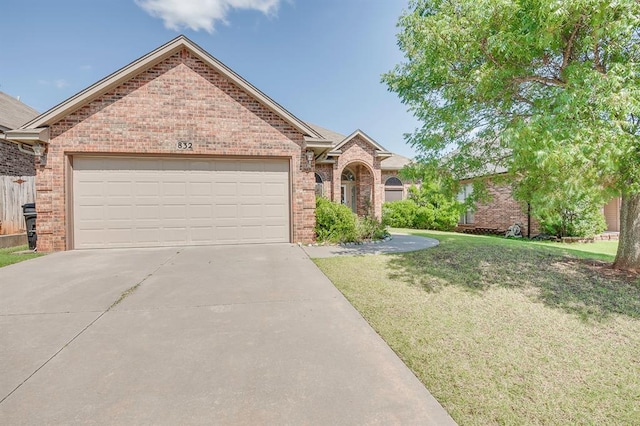 832 Elm Creek Dr, Moore, OK 73160 - view of front of home featuring brick siding, concrete driveway, a front yard, and a garage