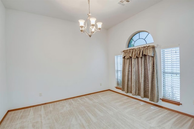 832 Elm Creek Dr, Moore, OK 73160 - empty room featuring a chandelier, baseboards, light carpet, and high vaulted ceiling