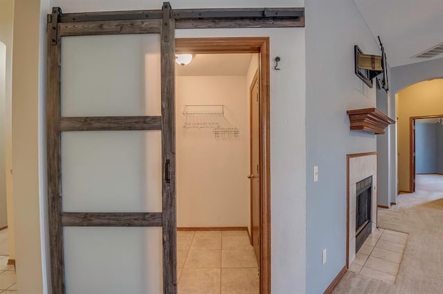 832 Elm Creek Dr, Moore, OK 73160 - hall featuring arched walkways, light tile patterned floors, and baseboards