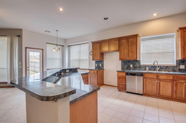 832 Elm Creek Dr, Moore, OK 73160 - kitchen with dishwasher, dark countertops, a sink, brown cabinets, and recessed lighting