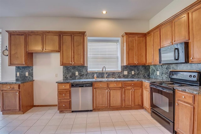 832 Elm Creek Dr, Moore, OK 73160 - kitchen with black appliances, a sink, brown cabinets, dark stone countertops, and backsplash