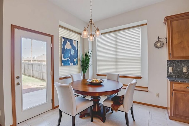 832 Elm Creek Dr, Moore, OK 73160 - dining area with light tile patterned flooring, baseboards, and a chandelier