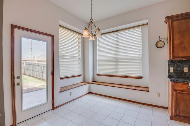 832 Elm Creek Dr, Moore, OK 73160 - unfurnished dining area with a chandelier and baseboards