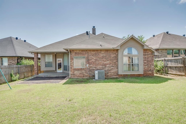 832 Elm Creek Dr, Moore, OK 73160 - back of house with central AC, a patio area, brick siding, a chimney, and a shingled roof