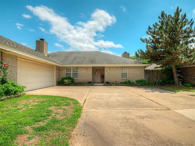 2604 Jeannes Trl, Edmond, OK 73012 - single story home with a chimney, brick siding, concrete driveway, and a garage