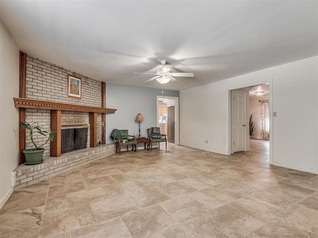 2604 Jeannes Trl, Edmond, OK 73012 - living area featuring ceiling fan, baseboards, a brick fireplace, and stone finish flooring