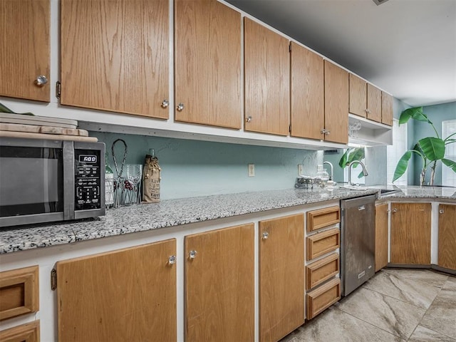 2604 Jeannes Trl, Edmond, OK 73012 - kitchen featuring appliances with stainless steel finishes, a sink, and light stone counters