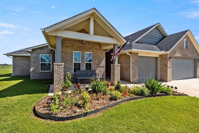 29731 Jade St, Cashion, OK 73016 - view of front of property with an attached garage, brick siding, a front lawn, concrete driveway, and a shingled roof