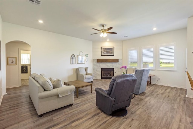 29731 Jade St, Cashion, OK 73016 - living room featuring arched walkways, a ceiling fan, a high end fireplace, wood finished floors, and recessed lighting