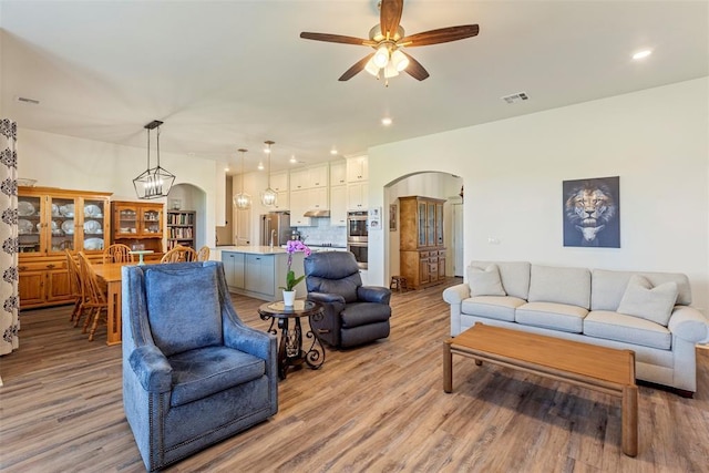 29731 Jade St, Cashion, OK 73016 - living room featuring arched walkways, a ceiling fan, light wood finished floors, and recessed lighting
