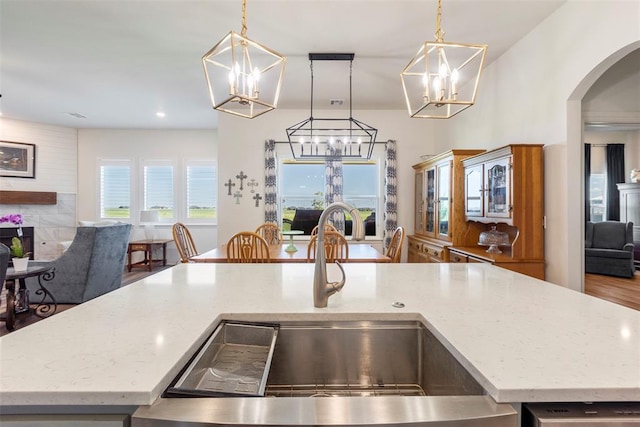 29731 Jade St, Cashion, OK 73016 - kitchen with open floor plan, a chandelier, arched walkways, light stone countertops, and recessed lighting