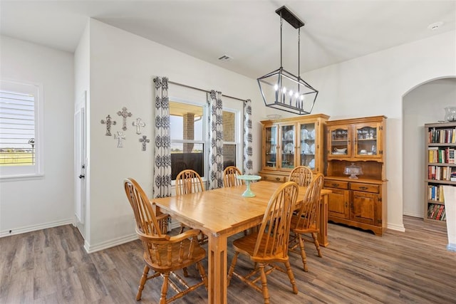 29731 Jade St, Cashion, OK 73016 - dining space with light wood-type flooring, healthy amount of natural light, and arched walkways